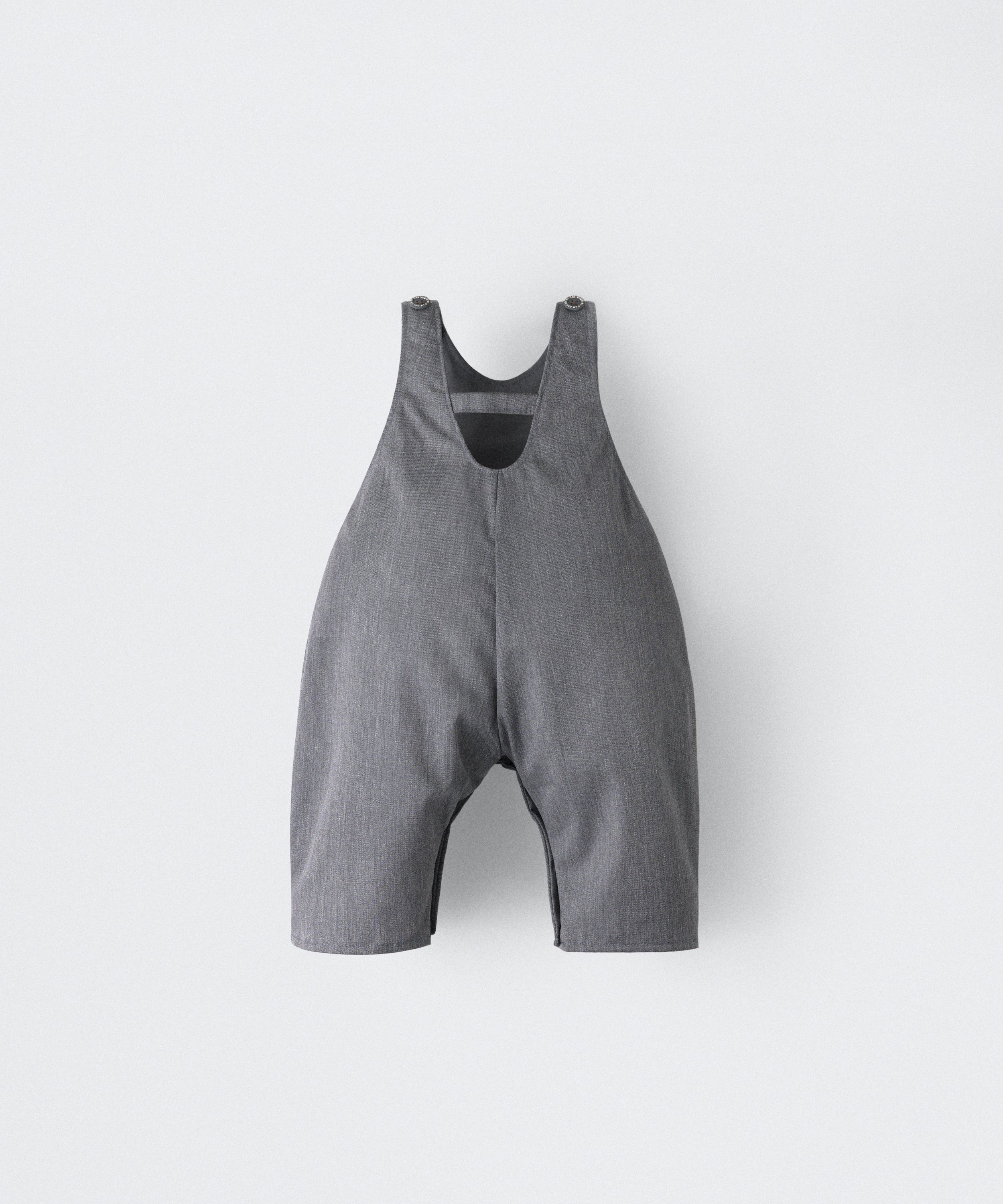 Espalda del Peto Land Baby en color gris azulado con tirantes con botones OEKO TEX. Confeccionado en sarga denim premium certificada GRS (Global Recycled Standard) y forro interior de 100 % algodón. Diseño efecto globo para la comodidad de tu bebé. www.kala.es