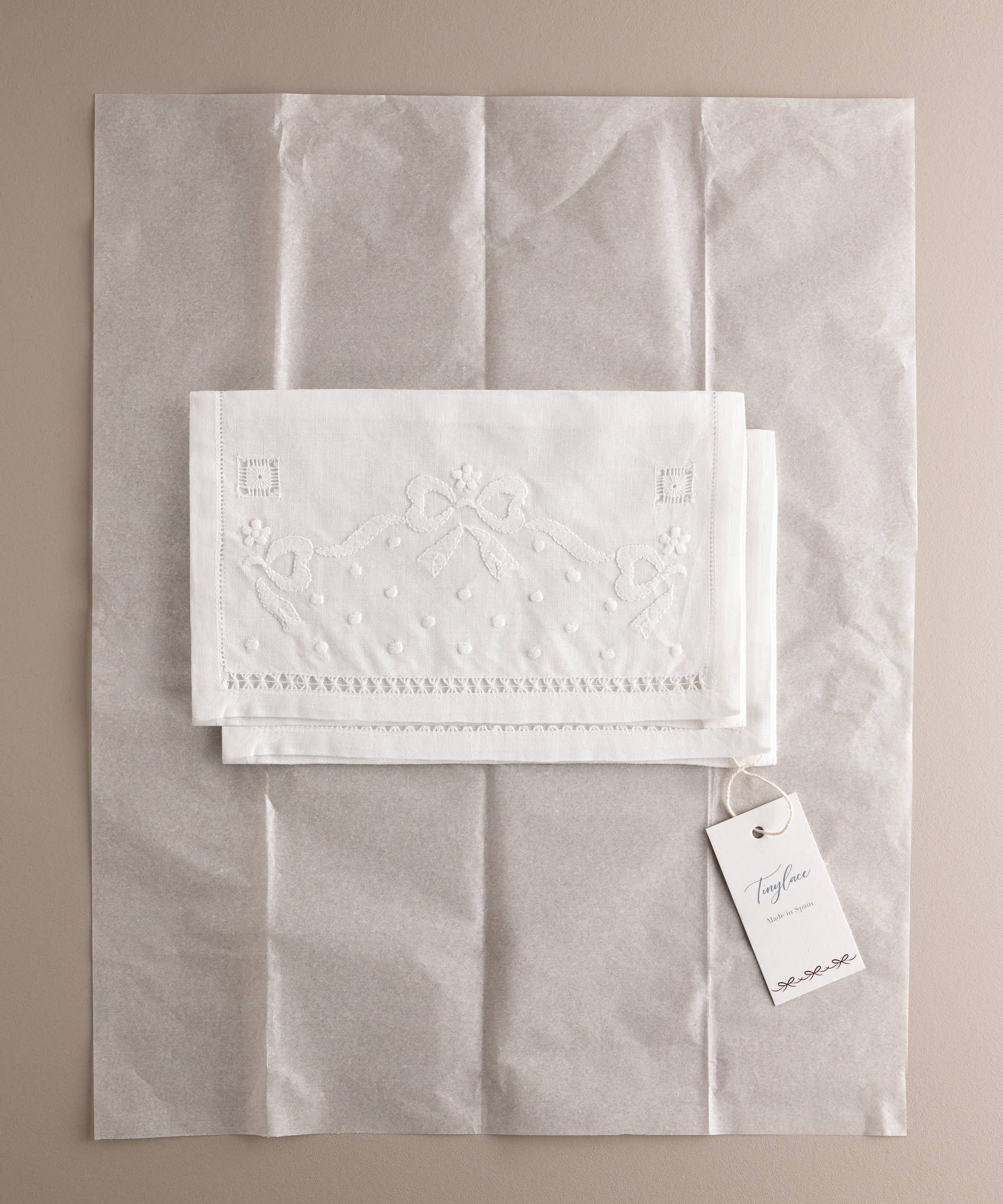 Set de dos bolsas de muda bebé de lino bordadas presentadas con papel de seda y etiqueta de marca